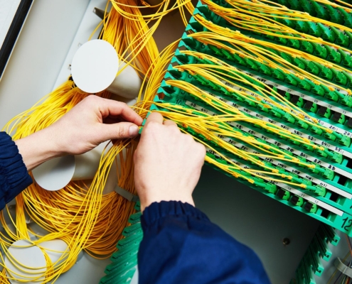 Worker installing fiber optic cabling