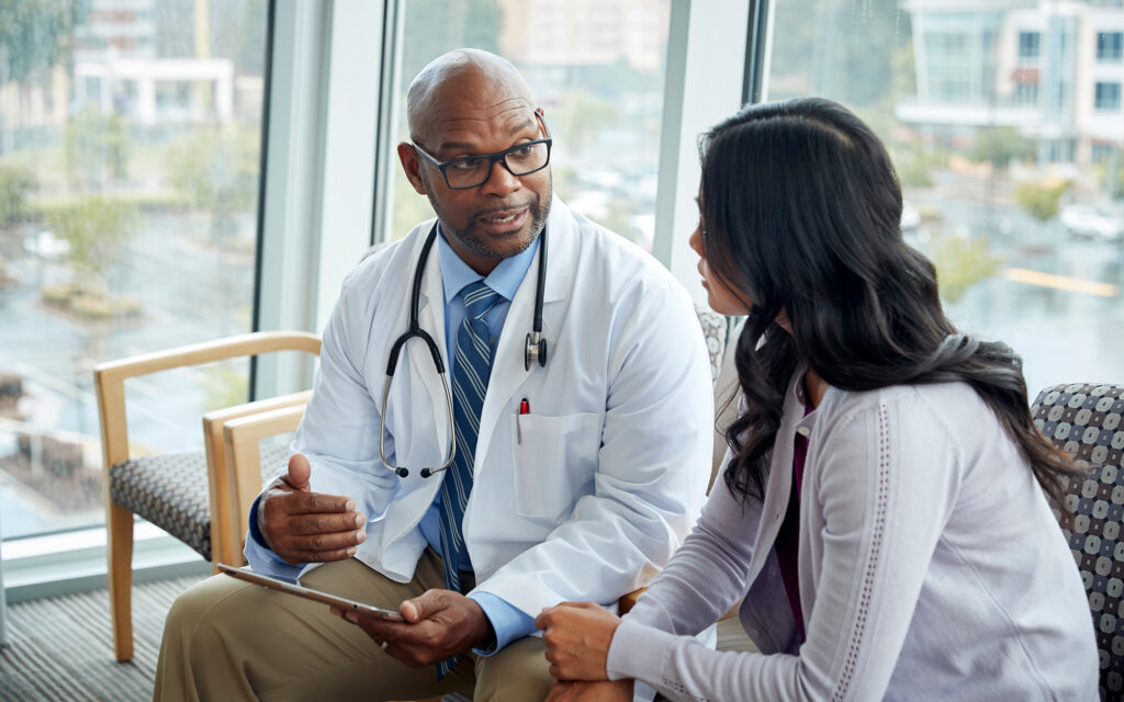 Doctor talking to woman in medical office